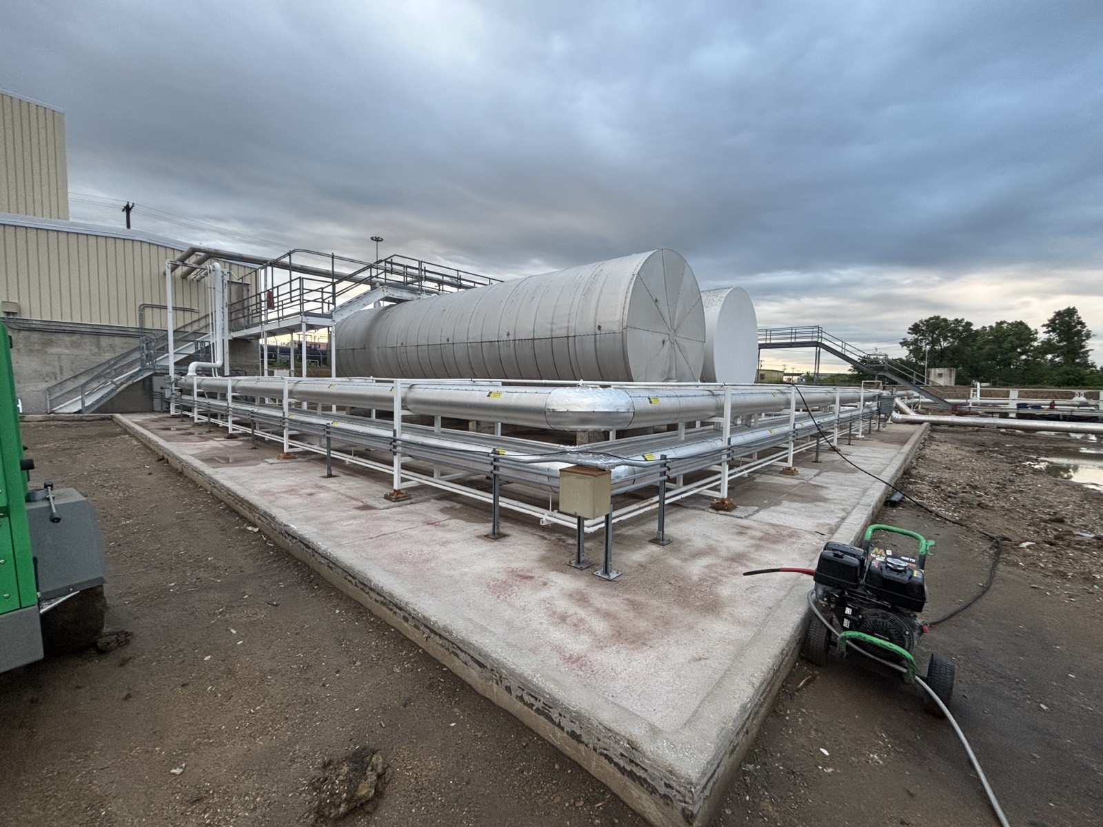Compressor-oil containment area after abrasive blasting and pressure washing, concrete and metal cleaned and prepared before coating