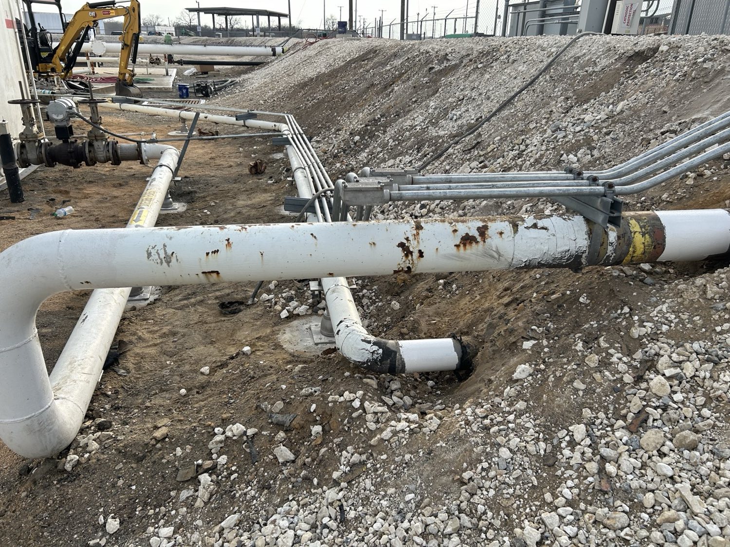 Existing process piping showing corrosion and coating deterioration before preparation and protective coating