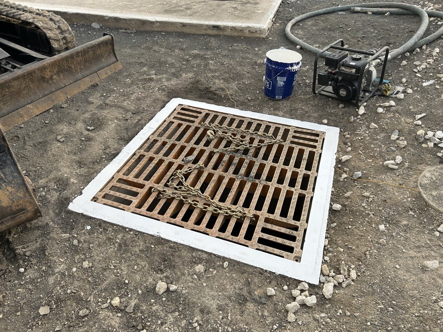 Drain structure with a primed and prepared perimeter, readied for integration with the containment liner