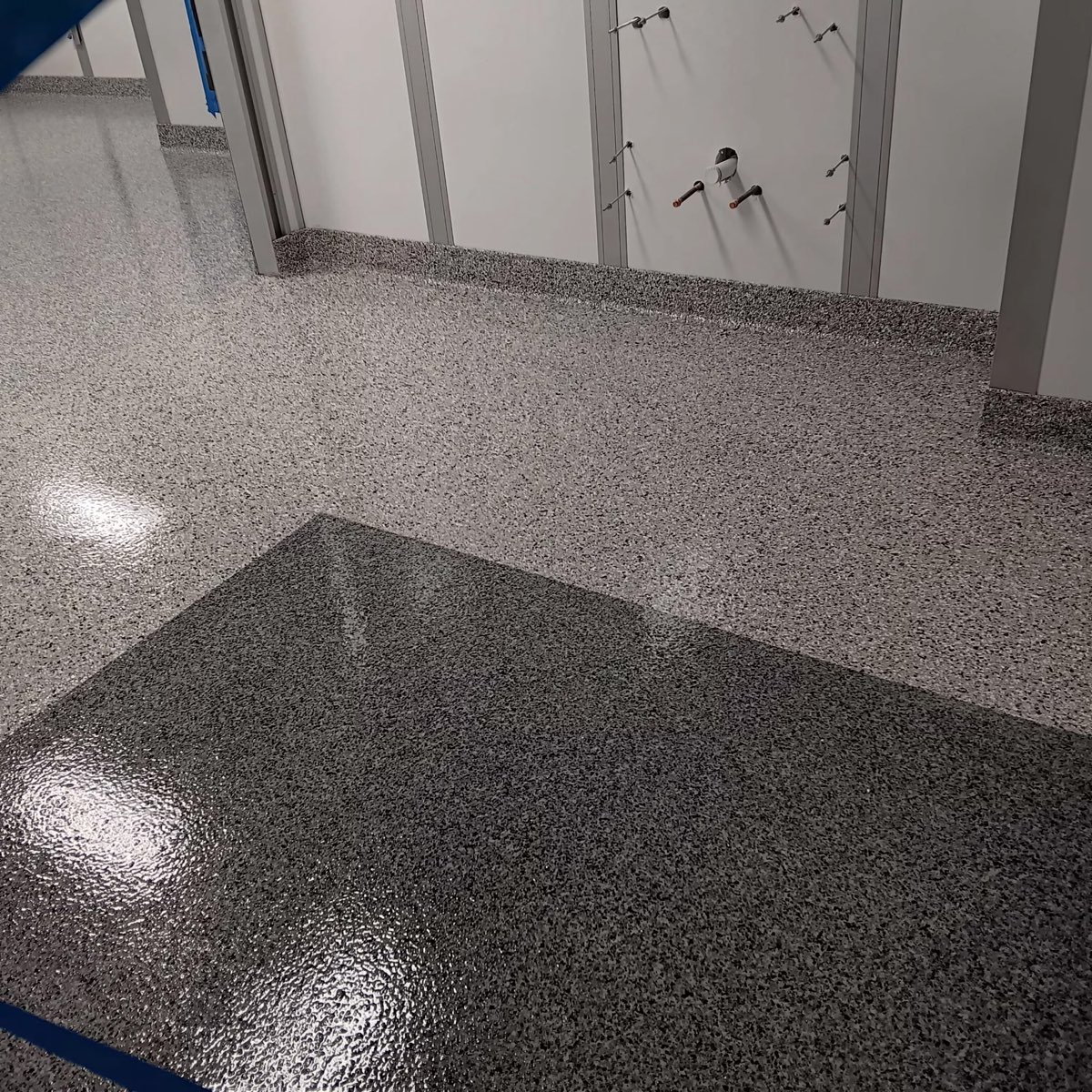 Two-tone gray flake clean room floor with integral cove base separating work zones